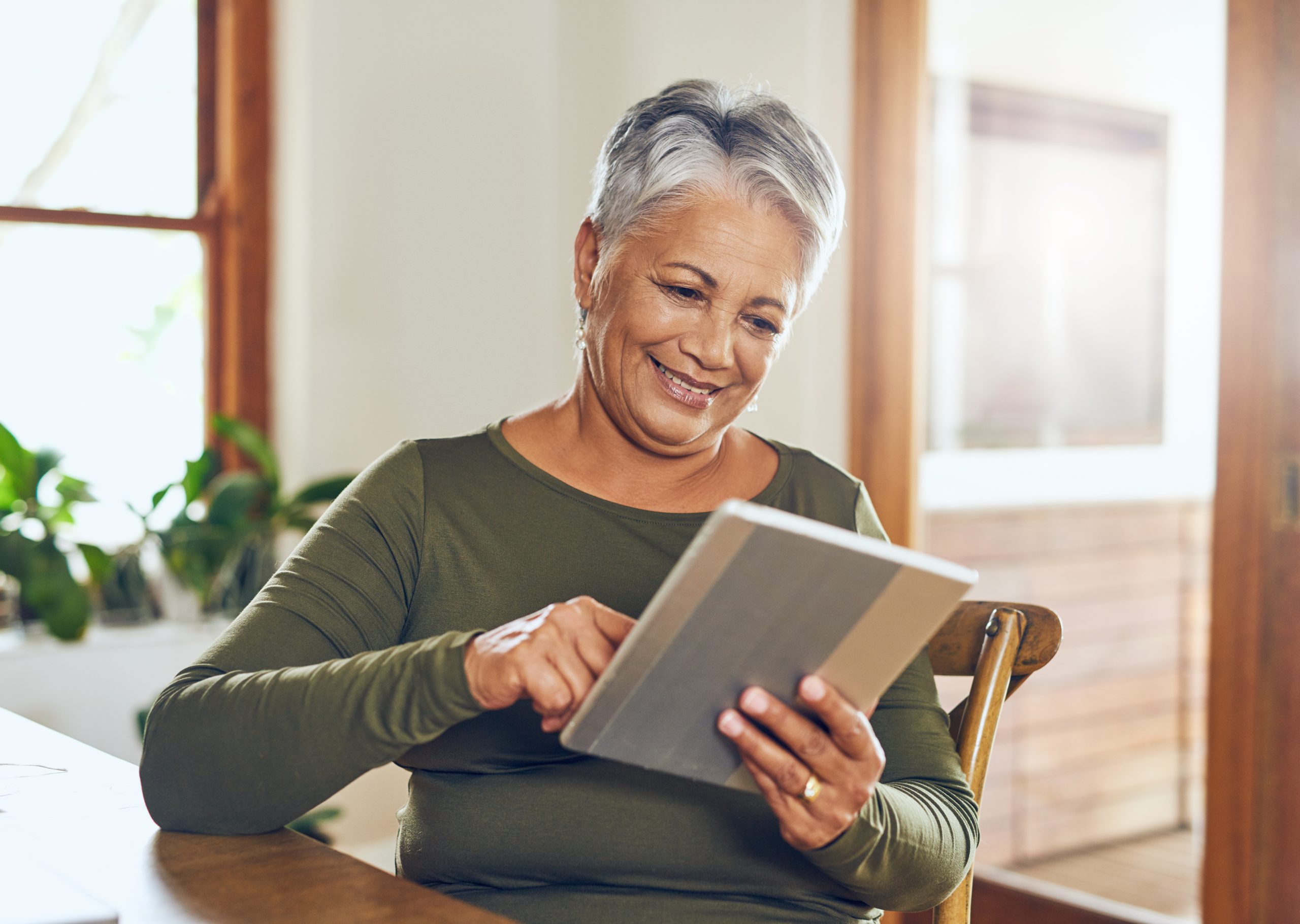 Shot of a mature woman using a digital tablet at home.